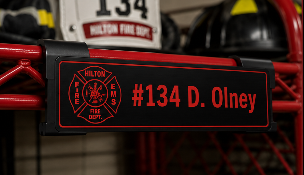 Black over red personalized firefighter gear locker nameplate mounted on a ready rack