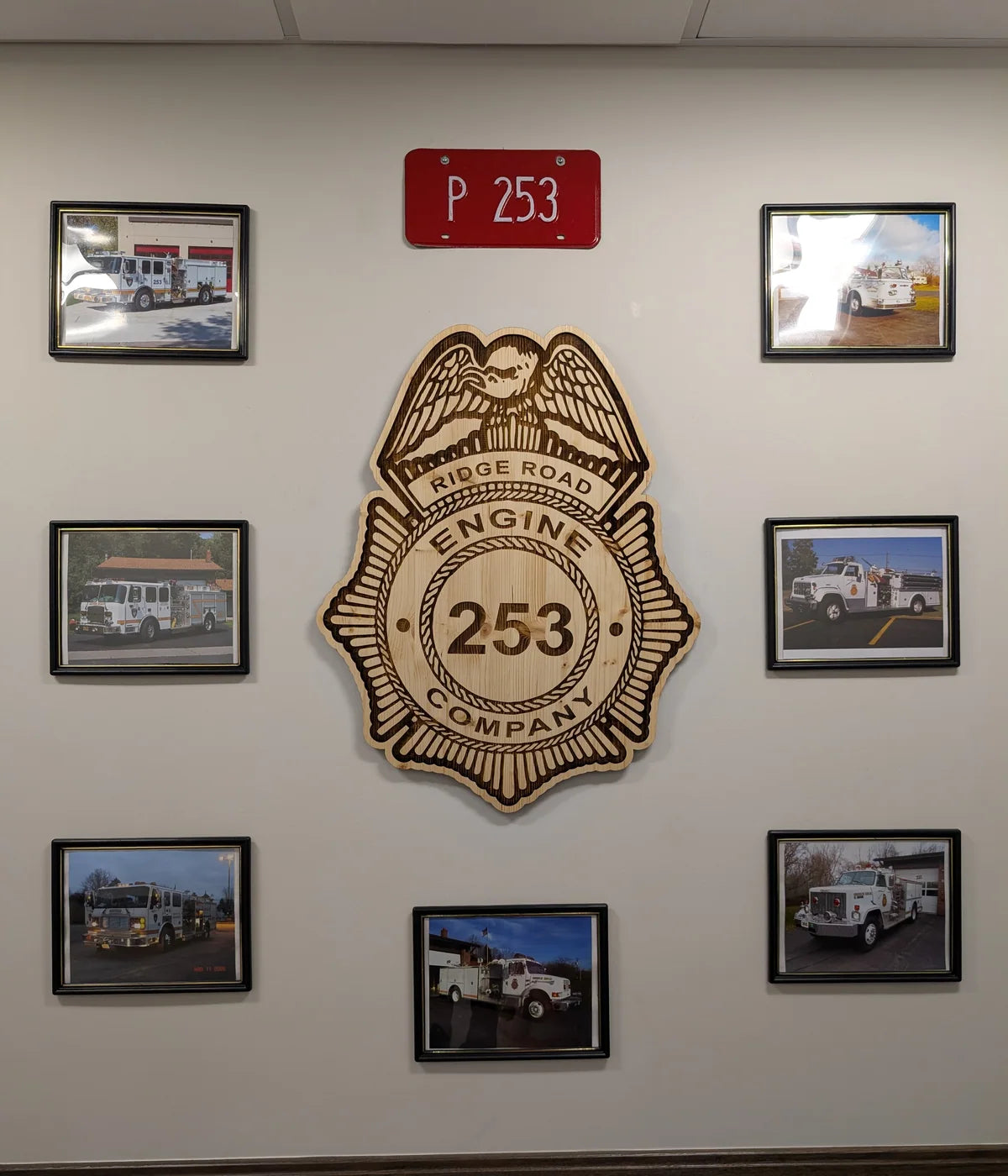 Large custom wooden firefighter badge installed on a fire station wall