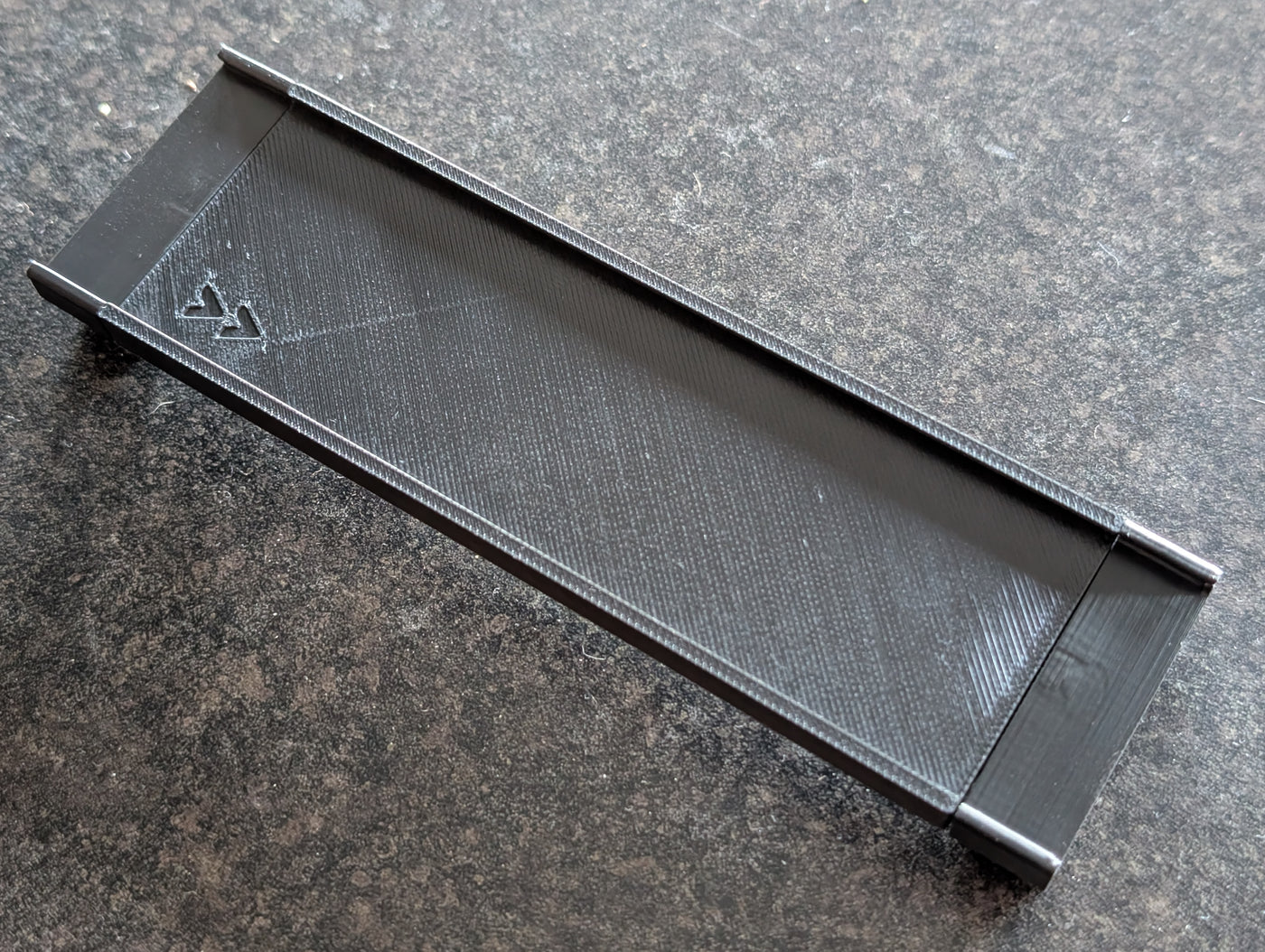 Black nameplate mount for a ReadyRack firefighter gear rack