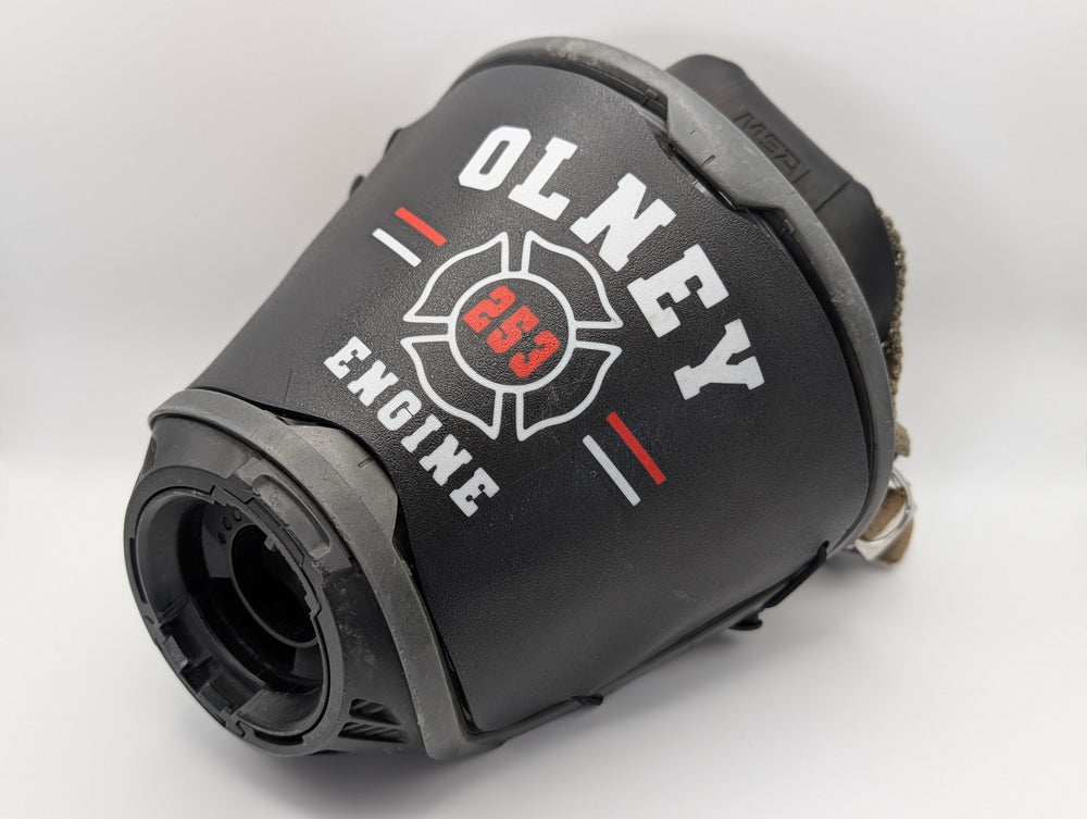 Company Maltese Cross SCBA mask cover installed on an MSA G1 facepiece; OLNEY, 253, and ENGINE shown as a personalization example.